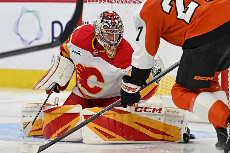 Nov 2, 2025; Philadelphia, Pennsylvania, USA; Calgary Flames goaltender Dustin Wolf (32) makes a save against the Philadelphia Flyers during the second period at Xfinity Mobile Arena. Mandatory Credit: Eric Hartline-Imagn Images