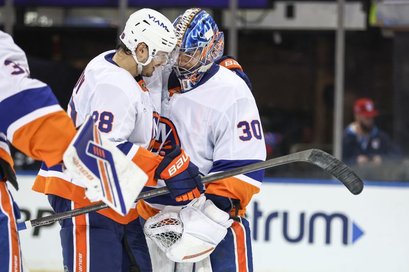 Nov 8, 2025; New York, New York, USA;  New York Islanders goaltender Ilya Sorokin (30) celebrates with defenseman Alexander Romanov (28) after defeating the New York Rangers 5-0 at Madison Square Garden. Mandatory Credit: Wendell Cruz-Imagn Images