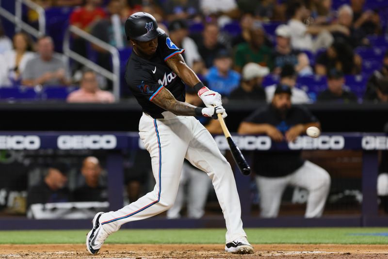 Apr 26, 2024; Miami, Florida, USA; Miami Marlins shortstop Tim Anderson (7) hits a single against the Washington Nationals during the fourth inning at loanDepot Park. Mandatory Credit: Sam Navarro-USA TODAY Sports