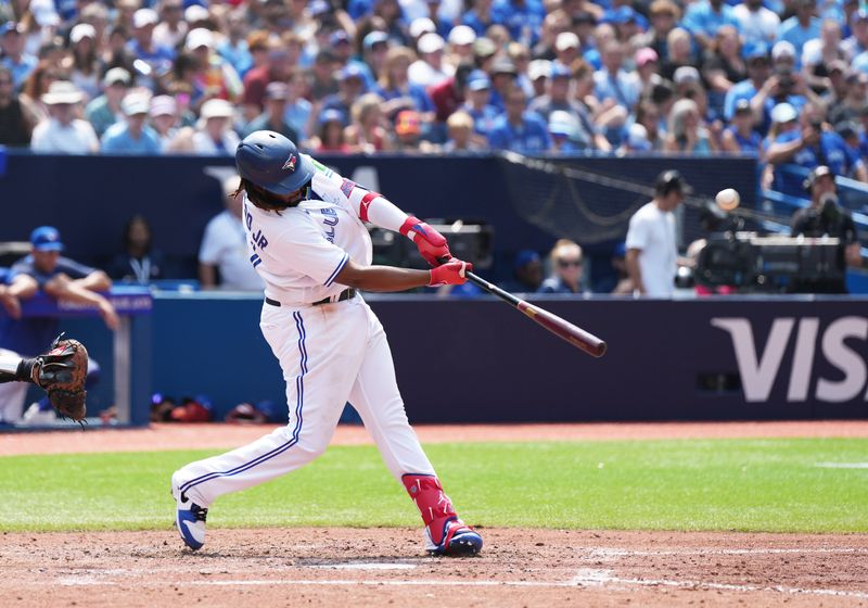 Jul 16, 2023; Toronto, Ontario, CAN; Toronto Blue Jays first baseman Vladimir Guerrero Jr. (27) hits a sacrifice fly ball scoring a run against the Arizona Diamondbacks during the sixth inning at Rogers Centre. Mandatory Credit: Nick Turchiaro-USA TODAY Sports