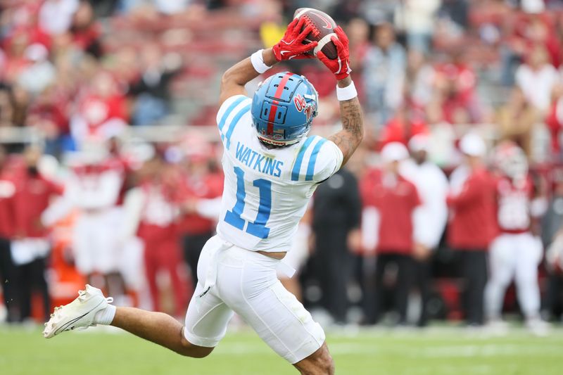 Nov 2, 2024; Fayetteville, Arkansas, USA; Ole Miss Rebels wide receiver Jordan Watkins (11) catches a pass in the fourth quarter and runs it in for a touchdown against the Arkansas Razorbacks at Donald W. Reynolds Razorback Stadium. Mississippi won 63-31. Mandatory Credit: Nelson Chenault-Imagn Images