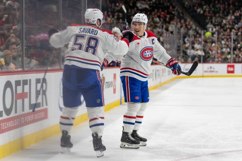 Dec 21, 2023; Saint Paul, Minnesota, USA; Montreal Canadiens defenseman David Savard (58) is congratulated by Montreal Canadiens center Nick Suzuki (14) after scoring against the Minnesota Wild in the second period at Xcel Energy Center. Mandatory Credit: Matt Blewett-USA TODAY Sports