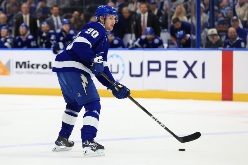 Jan 26, 2026; Tampa, Florida, USA; Tampa Bay Lightning defenseman J.J. Moser (90) skates with the puck against the Utah Mammoth during the first period at Benchmark International Arena. Mandatory Credit: Kim Klement Neitzel-Imagn Images
