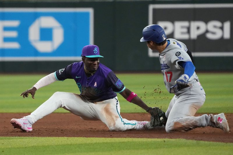 May 11, 2025; Phoenix, Arizona, USA; Arizona Diamondbacks shortstop Geraldo Perdomo (2) tags out Los Angeles Dodgers Shohei Ohtani (17) while trying to steal the base in the sixth inning at Chase Field. Mandatory Credit: Rick Scuteri-Imagn Images