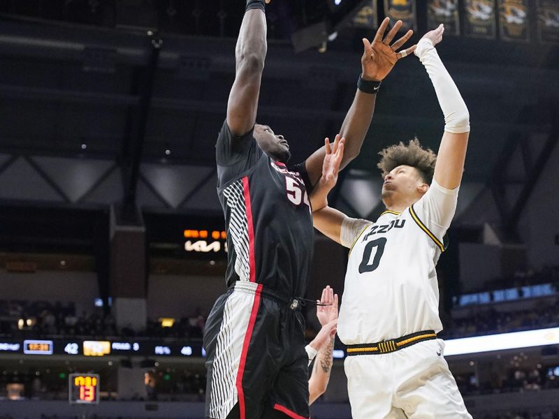 Jan 6, 2024; Columbia, Missouri, USA; Georgia Bulldogs center Russel Tchewa (54) shoots as Missouri Tigers forward Jordan Butler (0) defends during the second half at Mizzou Arena. Mandatory Credit: Denny Medley-USA TODAY Sports