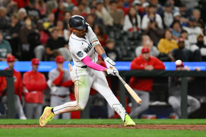 Sep 11, 2023; Seattle, Washington, USA; Seattle Mariners center fielder Julio Rodriguez (44) hits a two-run home run against the Los Angeles Angels during the tenth inning at T-Mobile Park. Mandatory Credit: Steven Bisig-USA TODAY Sports