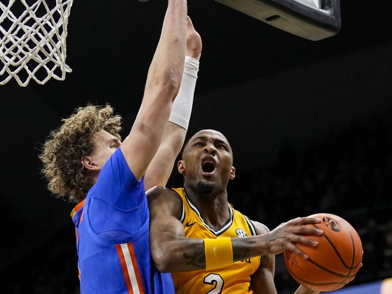 Jan 20, 2024; Columbia, Missouri, USA; Missouri Tigers guard Tamar Bates (2) goes up for a shot against Florida Gators center Micah Handlogten (3) during the first half at Mizzou Arena. Mandatory Credit: Jay Biggerstaff-USA TODAY Sports