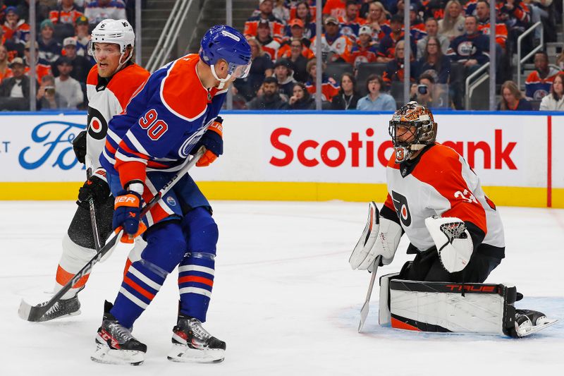 Oct 15, 2024; Edmonton, Alberta, CAN; Edmonton Oilers forward Corey Perry (90) looks for the puck in front of Philadelphia Flyers goaltender Samuel Ersson (33) during the first period at Rogers Place. Mandatory Credit: Perry Nelson-Imagn Images