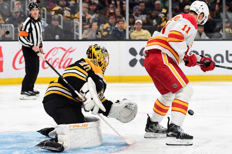 Nov 7, 2024; Boston, Massachusetts, USA;  Calgary Flames center Mikael Backlund (11) screens Boston Bruins goaltender Joonas Korpisalo (70) during the second period at TD Garden. Mandatory Credit: Bob DeChiara-Imagn Images