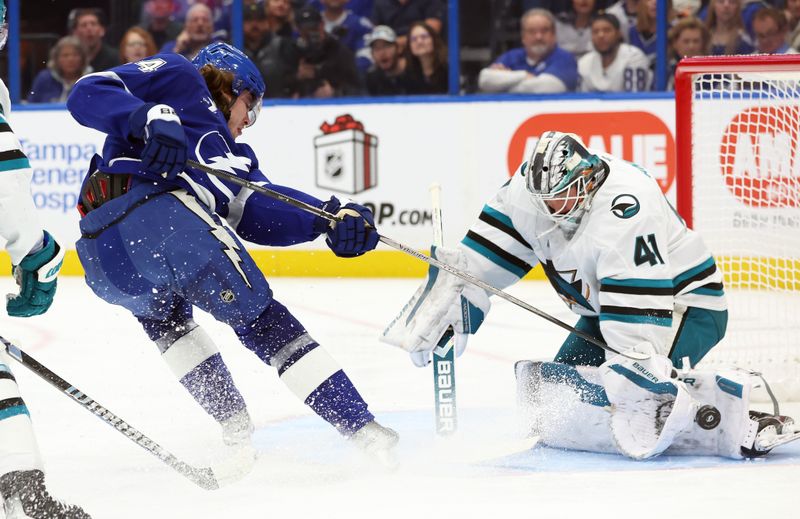 Dec 5, 2024; Tampa, Florida, USA; Tampa Bay Lightning center Conor Geekie (14) shoots against San Jose Sharks goaltender Vitek Vanecek (41) during the first period at Amalie Arena. Mandatory Credit: Kim Klement Neitzel-Imagn Images