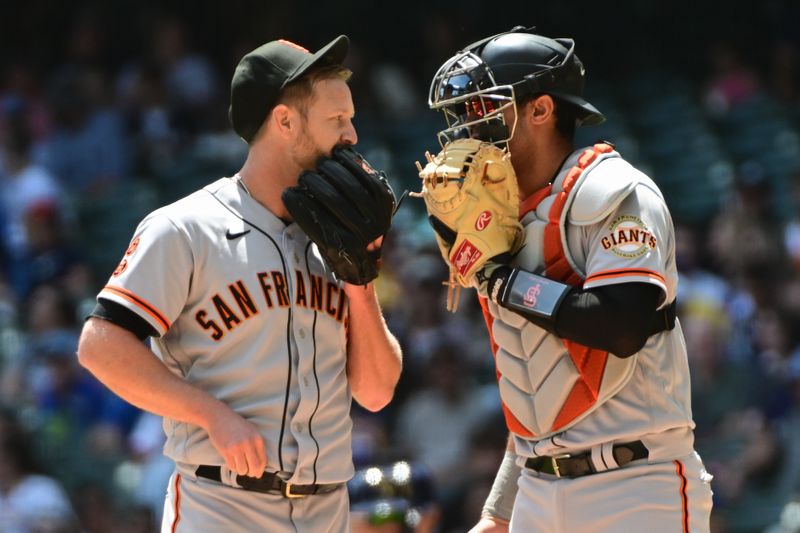 May 28, 2023; Milwaukee, Wisconsin, USA; San Francisco Giants pitcher Alex Cobb (38) and catcher Blake Sabol (2) talk during a mound visit in the first inning against the Milwaukee Brewers at American Family Field. Mandatory Credit: Benny Sieu-USA TODAY Sports