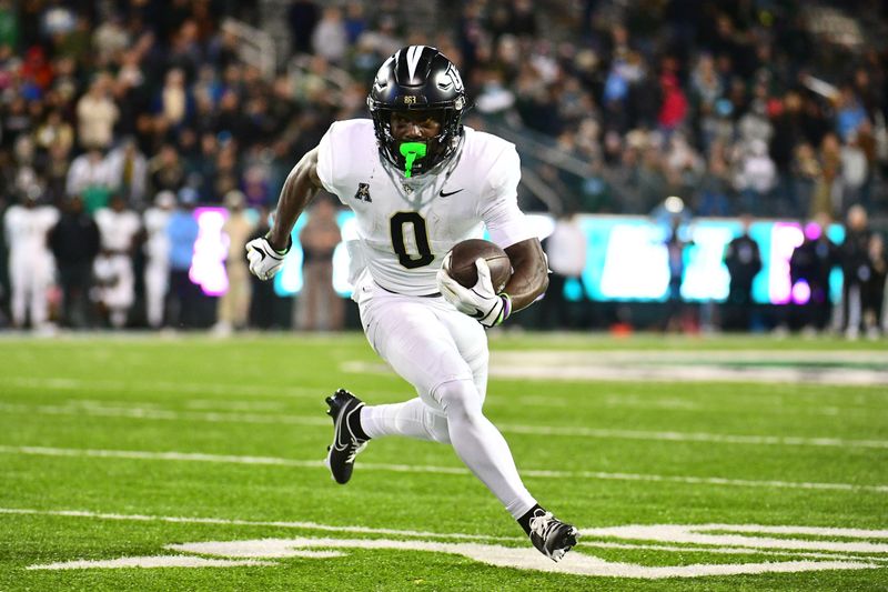 Nov 12, 2022; New Orleans, Louisiana, USA; UCF Knights running back Johnny Richardson (0) runs the ball against the Tulane Green Wave during the fourth quarter at Yulman Stadium. Mandatory Credit: Rebecca Warren-USA TODAY Sports