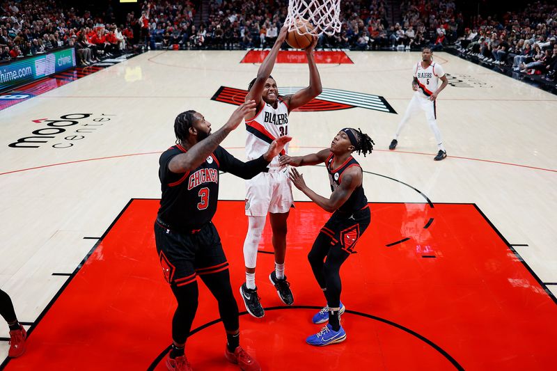 PORTLAND, OREGON - MARCH 24: Jabari Walker #34 of the Portland Trail Blazers drives for a dunk against Ayo Dosunmu #12 (R) of the Chicago Bulls during the second half at Moda Center on March 24, 2023 in Portland, Oregon. NOTE TO USER: User expressly acknowledges and agrees that, by downloading and or using this photograph, User is consenting to the terms and conditions of the Getty Images License Agreement. (Photo by Soobum Im/Getty Images)