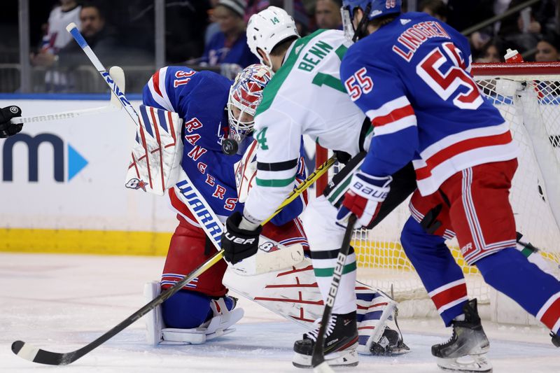 Feb 20, 2024; New York, New York, USA; New York Rangers goaltender Igor Shesterkin (31) makes a save in front of Dallas Stars left wing Jamie Benn (14) and Rangers defenseman Ryan Lindgren (55) during the second period at Madison Square Garden. Mandatory Credit: Brad Penner-USA TODAY Sports