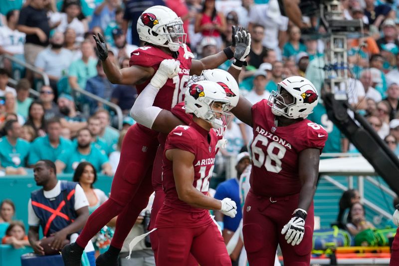 Arizona Cardinals wide receiver Marvin Harrison Jr. (18) celebrates his touchdown during the second half of an NFL football game against the Miami Dolphins, Sunday, Oct. 27, 2024, in Miami Gardens, Fla. (AP Photo/Lynne Sladky)