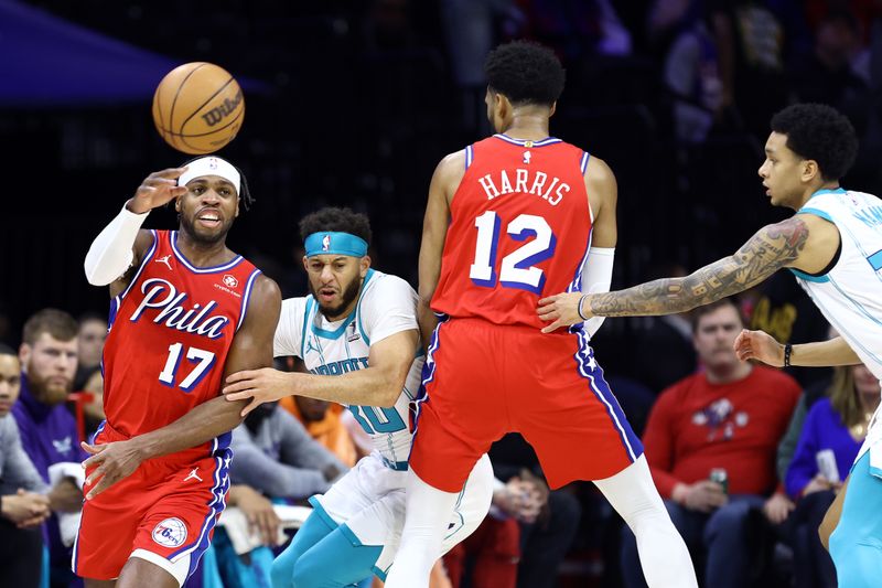 PHILADELPHIA, PENNSYLVANIA - MARCH 01: Buddy Hield #17 of the Philadelphia 76ers passes past Seth Curry #30 of the Charlotte Hornets during the first quarter at the Wells Fargo Center on March 01, 2024 in Philadelphia, Pennsylvania. NOTE TO USER: User expressly acknowledges and agrees that, by downloading and or using this photograph, User is consenting to the terms and conditions of the Getty Images License Agreement.  (Photo by Tim Nwachukwu/Getty Images)