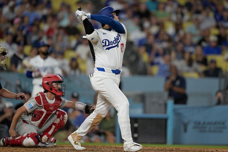 Aug 5, 2024; Los Angeles, California, USA;  Los Angeles Dodgers designated hitter Shohei Ohtani (17) hits a solo home run in the eighth inning against the Philadelphia Phillies at Dodger Stadium. Mandatory Credit: Jayne Kamin-Oncea-USA TODAY Sports