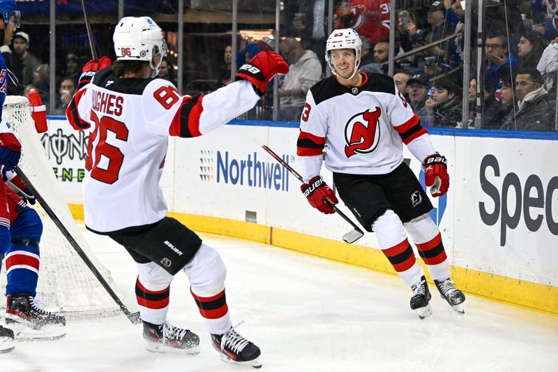 Dec 2, 2024; New York, New York, USA; New Jersey Devils left wing Jesper Bratt (63) celebrates his goal with New Jersey Devils center Jack Hughes (86) against the New York Rangers during the first period at Madison Square Garden. Mandatory Credit: Dennis Schneidler-Imagn Images