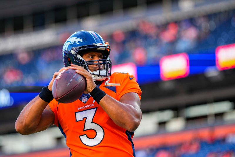 Denver Broncos quarterback Russell Wilson (3) warms up against the Minnesota Vikings during an NFL preseason football game, Saturday, Aug. 27, 2022, in Denver. (AP Photo/Jack Dempsey)