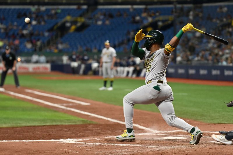 May 29, 2024; St. Petersburg, Florida, USA; Oakland Athletics left fielder Miguel Andujar (22) hits a RBI single in the sixth inning against the Tampa Bay Rays at Tropicana Field. Mandatory Credit: Jonathan Dyer-USA TODAY Sports