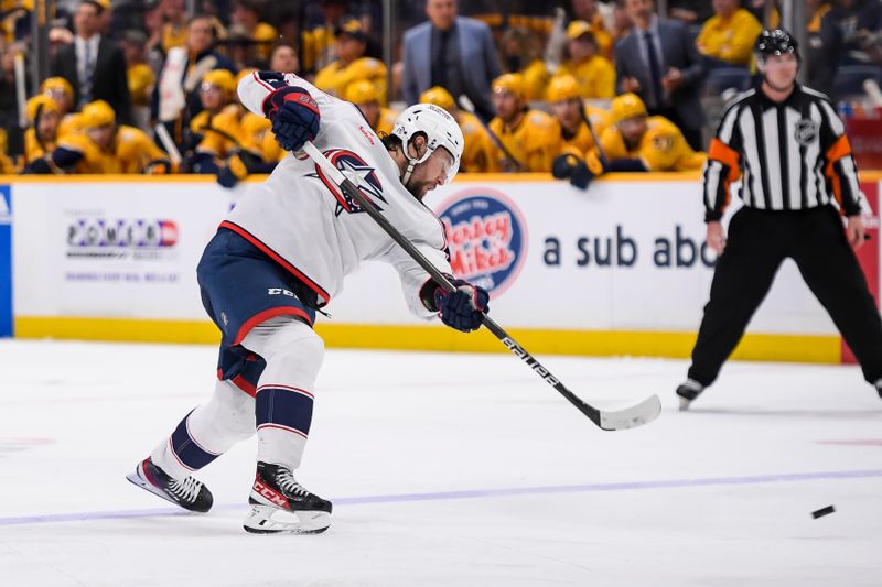 Apr 13, 2024; Nashville, Tennessee, USA; Columbus Blue Jackets right wing Mathieu Olivier (24) takes a shot on goal against the Nashville Predators during the second period at Bridgestone Arena. Mandatory Credit: Steve Roberts-USA TODAY Sports