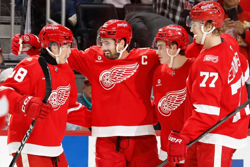 Oct 19, 2025; Detroit, Michigan, USA;  Detroit Red Wings center Dylan Larkin (71) celebrates with his teammates after scoring a goal against the Edmonton Oilers during the second period at Little Caesars Arena. Mandatory Credit: Rick Osentoski-Imagn Images