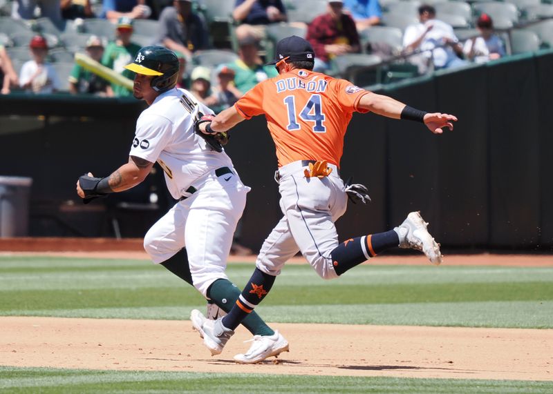 Jul 23, 2023; Oakland, California, USA; Oakland Athletics designated hitter Jordan Diaz (13) is tagged out by Houston Astros second baseman Mauricio Dubon (14) during the fifth inning at Oakland-Alameda County Coliseum. Mandatory Credit: Kelley L Cox-USA TODAY Sports