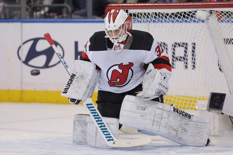 Mar 11, 2024; New York, New York, USA; New Jersey Devils goaltender Kaapo Kahkonen (31) makes a save against the New York Rangers during the first period at Madison Square Garden. Mandatory Credit: Brad Penner-USA TODAY Sports