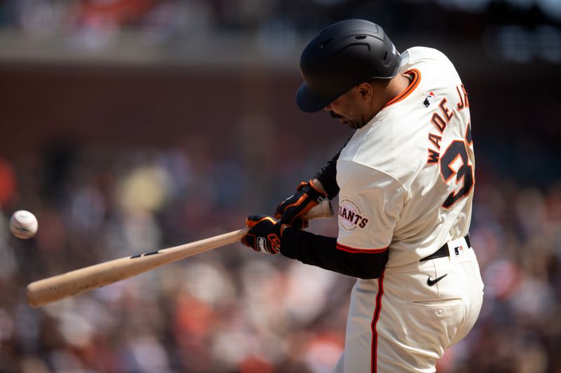 May 18, 2024; San Francisco, California, USA; San Francisco Giants first baseman LaMonte Wade Jr. (31) connects for a single against the Colorado Rockies during the eighth inning at Oracle Park. Mandatory Credit: D. Ross Cameron-USA TODAY Sports