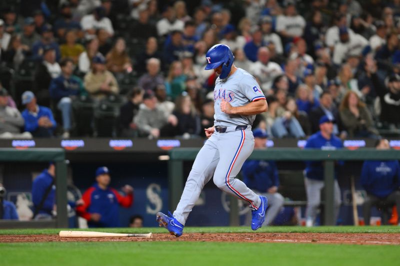 Sep 12, 2024; Seattle, Washington, USA; Texas Rangers left fielder Wyatt Langford (36) scores a run against the Seattle Mariners during the eighth inning at T-Mobile Park. Mandatory Credit: Steven Bisig-Imagn Images