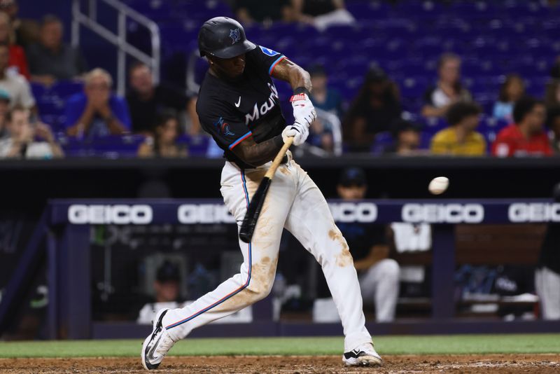 Jun 21, 2024; Miami, Florida, USA; Miami Marlins shortstop Tim Anderson (7) hits a walk-off single against the Seattle Mariners during the tenth inning at loanDepot Park. Mandatory Credit: Sam Navarro-USA TODAY Sports