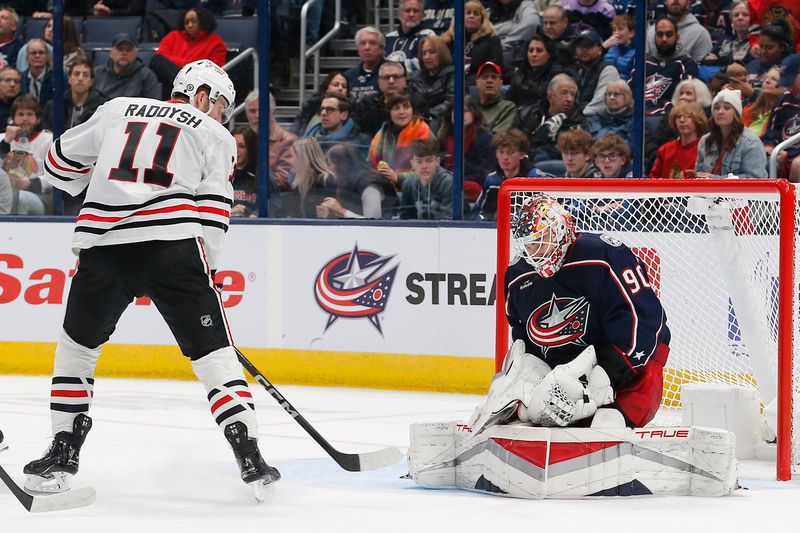 Nov 22, 2023; Columbus, Ohio, USA; Columbus Blue Jackets goalie Elvis Merzlikins (90) makes a save on the shot of Chicago Blackhawks right wing Taylor Raddysh (11) during the second period at Nationwide Arena. Mandatory Credit: Russell LaBounty-USA TODAY Sports