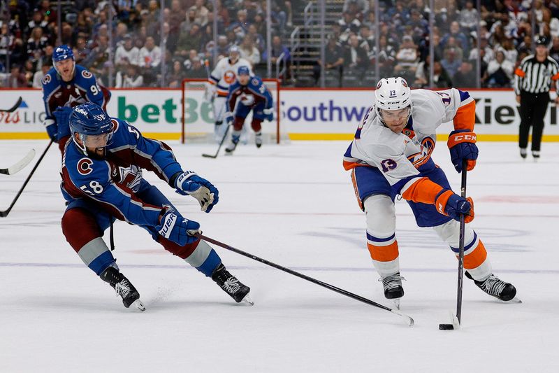 Oct 14, 2024; Denver, Colorado, USA; New York Islanders center Mathew Barzal (13) controls the puck as Colorado Avalanche defenseman Oliver Kylington (58) defends in the first period at Ball Arena. Mandatory Credit: Isaiah J. Downing-Imagn Images