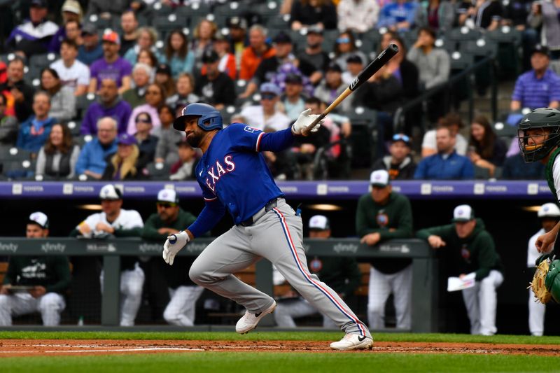 May 11, 2024; Denver, Colorado, USA; Texas Rangers designated hitter Ezequiel Duran (20) hits a single against the Colorado Rockies during the second inning at Coors Field. Mandatory Credit: John Leyba-USA TODAY Sports