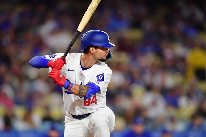 Apr 16, 2024; Los Angeles, California, USA; Los Angeles Dodgers center fielder Andy Pages (84) hits during his major league debut against the Washington Nationals during the second inning at Dodger Stadium. Mandatory Credit: Gary A. Vasquez-USA TODAY Sports