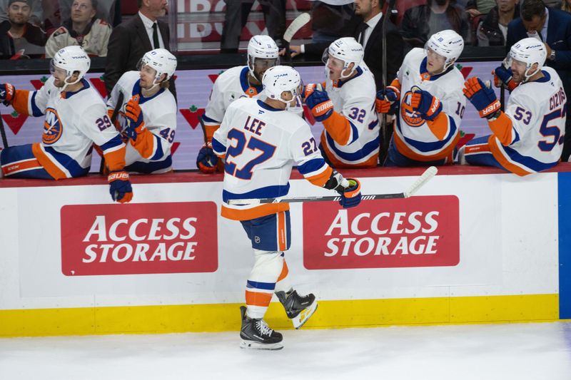 Oct 18, 2025; Ottawa, Ontario, CAN; New York Islanders left wing Anders Lee (27) celebrates with teammates after scoring in the third period against the  Ottawa Senators at the Canadian Tire Centre. Mandatory Credit: Marc DesRosiers-IMAGN Images