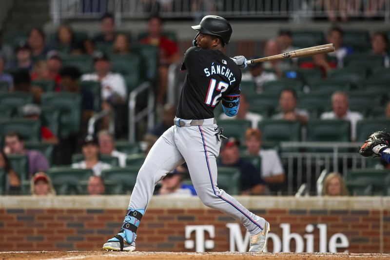 Aug 3, 2024; Atlanta, Georgia, USA; Miami Marlins right fielder Jesus Sanchez (12) hits a single against the Atlanta Braves in the ninth inning at Truist Park. Mandatory Credit: Brett Davis-USA TODAY Sports