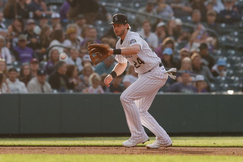 Jun 30, 2023; Denver, Colorado, USA; Colorado Rockies third baseman Ryan McMahon (24) fields the ball in the fifth inning against the Detroit Tigers at Coors Field. Mandatory Credit: Isaiah J. Downing-USA TODAY Sports