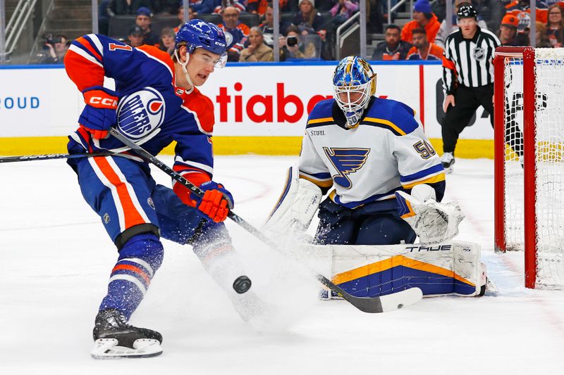 Feb 28, 2024; Edmonton, Alberta, CAN; Edmonton Oilers forward Ryan McLeod (71) tries to gather up a loose puck in front of St. Louis Blues goaltender Jordan Binnington (50) during the first period at Rogers Place. Mandatory Credit: Perry Nelson-USA TODAY Sports