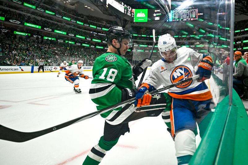 Oct 12, 2024; Dallas, Texas, USA; Dallas Stars center Sam Steel (18) checks New York Islanders right wing Oliver Wahlstrom (26) during the third period at the American Airlines Center. Mandatory Credit: Jerome Miron-Imagn Images