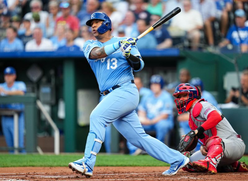 Aug 11, 2023; Kansas City, Missouri, USA; Kansas City Royals catcher Salvador Perez (13) hits an RBI double against the St. Louis Cardinals during the first inning at Kauffman Stadium. Mandatory Credit: Jay Biggerstaff-USA TODAY Sports