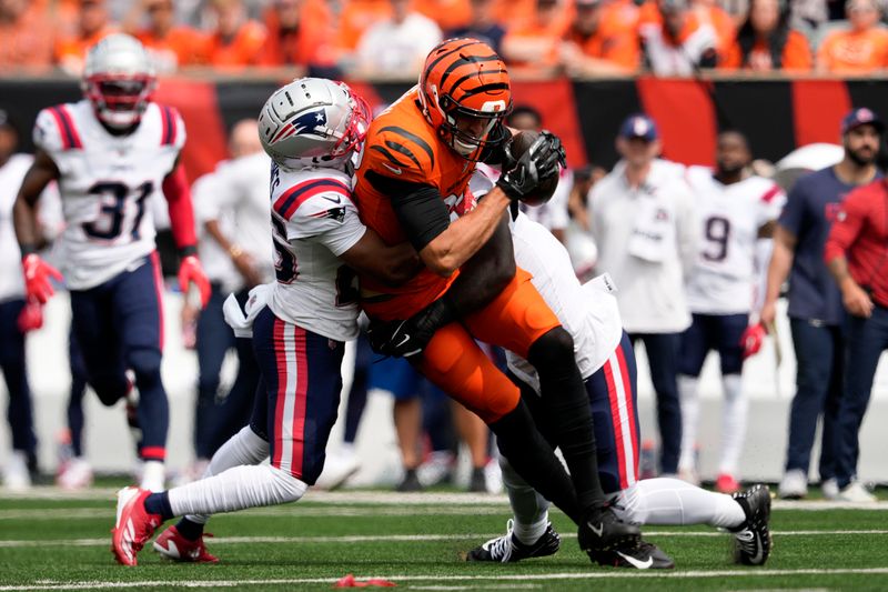 Cincinnati Bengals tight end Mike Gesicki (88) is tackled by New England Patriots cornerback Marcus Jones, left, after catching a pass during the first half of an NFL football game, Sunday, Sept. 8, 2024, in Cincinnati. (AP Photo/Jeff Dean)