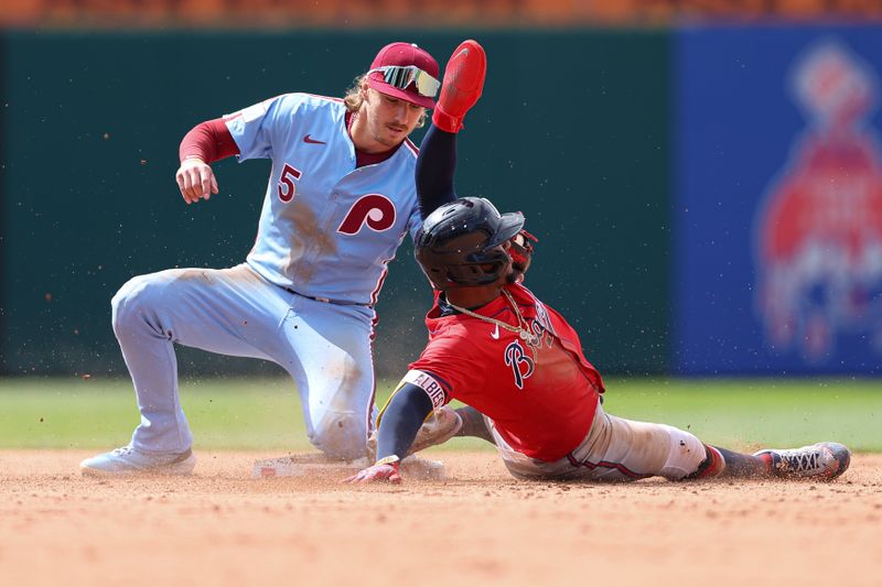 May 29, 2025; Philadelphia, Pennsylvania, USA; Philadelphia Phillies second base Bryson Stott (5) tags out Atlanta Braves second base Ozzie Albies (1) on a stolen base attempt during the ninth inning at Citizens Bank Park. Mandatory Credit: Bill Streicher-Imagn Images