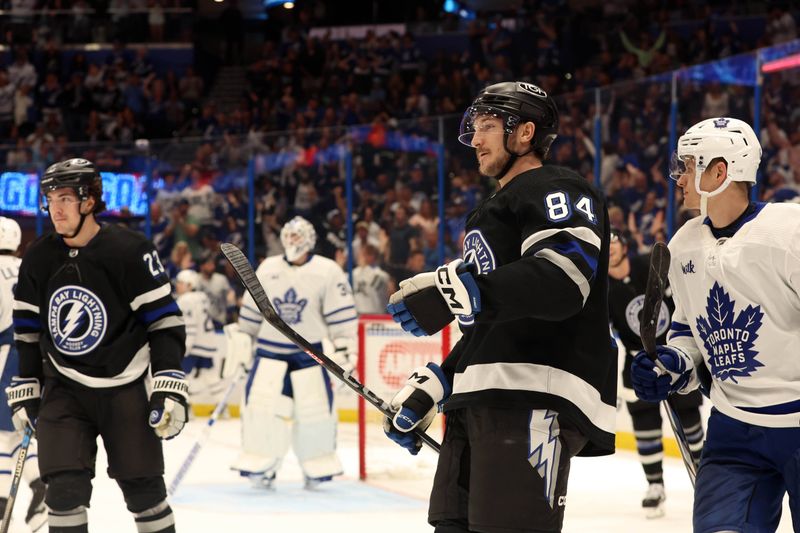 Apr 17, 2024; Tampa, Florida, USA; Tampa Bay Lightning left wing Tanner Jeannot (84) is congratulated after scoring against the Toronto Maple Leafs during the third period at Amalie Arena. Mandatory Credit: Kim Klement Neitzel-USA TODAY Sports