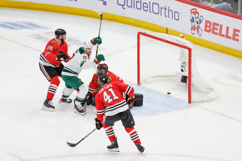 Feb 7, 2024; Chicago, Illinois, USA; Minnesota Wild left wing Marcus Foligno (17) celebrates after scoring against Chicago Blackhawks goaltender Petr Mrazek (34) during the third period at United Center. Mandatory Credit: Kamil Krzaczynski-USA TODAY Sports