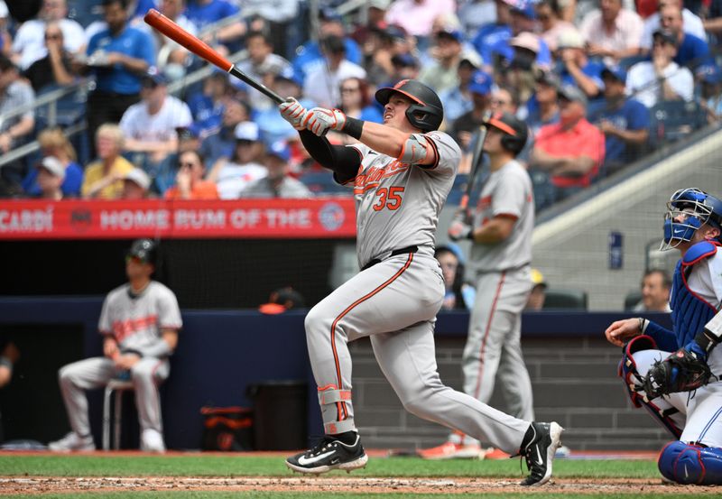 Jun 6, 2024; Toronto, Ontario, CAN;  Baltimore Orioles designated hitter Adley Rutschman (35) hits a solo home run against the Toronto Blue Jays in the sixth inning at Rogers Centre. Mandatory Credit: Dan Hamilton-USA TODAY Sports