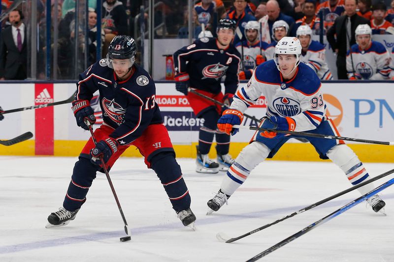 Mar 7, 2024; Columbus, Ohio, USA; Columbus Blue Jackets left wing Johnny Gaudreau (13) carries the puck as Edmonton Oilers center Ryan Nugent-Hopkins (93) trails the play during the first period at Nationwide Arena. Mandatory Credit: Russell LaBounty-USA TODAY Sports