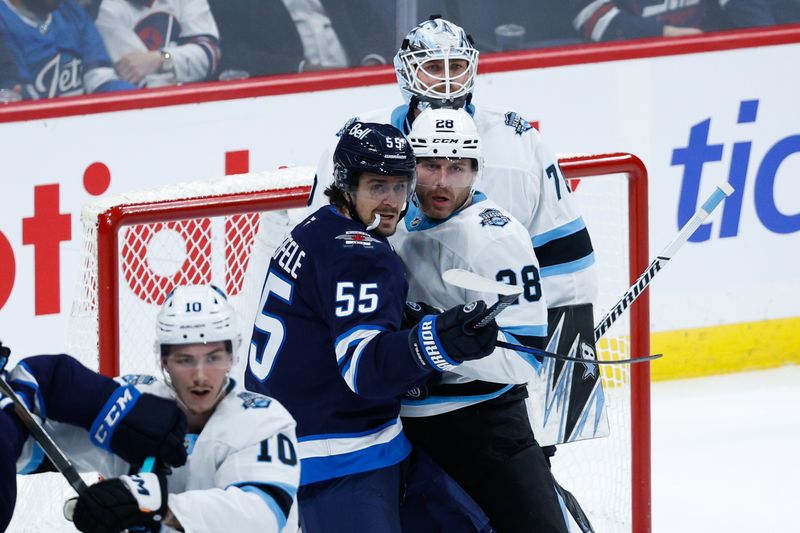 Nov 5, 2024; Winnipeg, Manitoba, CAN;  Winnipeg Jets forward Mark Scheifele (55) jostles for position with Utah Hockey Club defenseman Ian Cole (28) in front of Utah Hockey Club goalie Karel Vejmelka (70) during the third period at Canada Life Centre. Mandatory Credit: Terrence Lee-Imagn Images