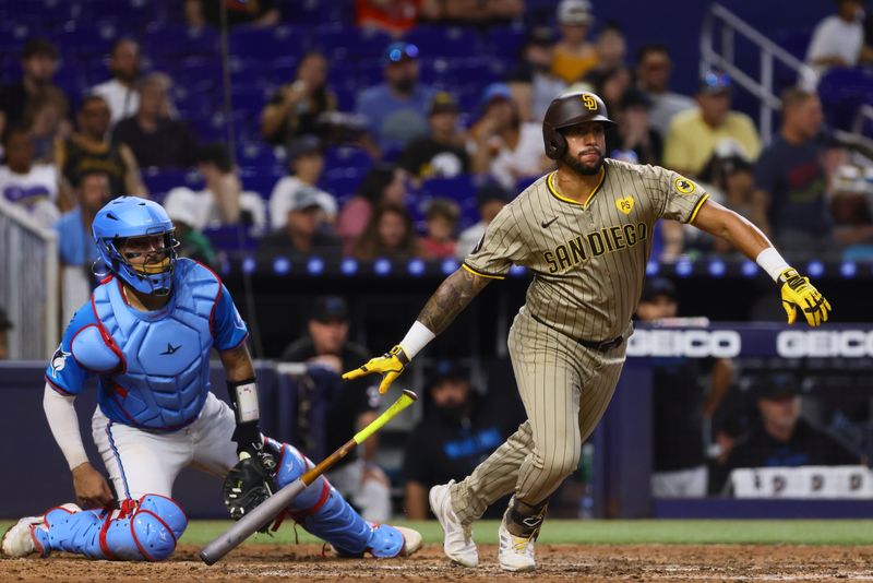 Aug 11, 2024; Miami, Florida, USA; San Diego Padres right fielder David Peralta (24) hits an RBI double against the Miami Marlins during the seventh inning at loanDepot Park. Mandatory Credit: Sam Navarro-USA TODAY Sports