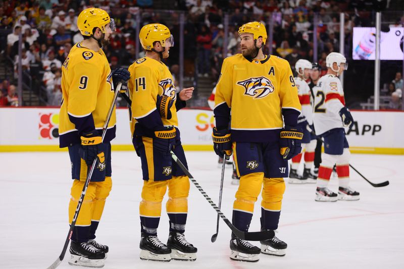 Mar 21, 2024; Sunrise, Florida, USA; Nashville Predators center Ryan O'Reilly (90), center Gustav Nyquist (14) and left wing Filip Forsberg (9) talk against the Florida Panthers during the first period at Amerant Bank Arena. Mandatory Credit: Sam Navarro-USA TODAY Sports